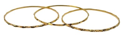 Lot 242 - Patterned Yellow Gold Bangles.