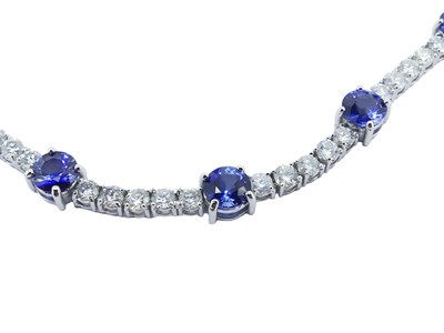 Lot 77 - Diamond and Sapphire Tennis Style Necklace.